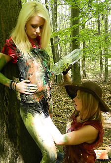 Smoking hot cuties painting on their clothes in the woods