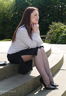 Lovely Sara is outdoors posing in a pair of silky nylon stockings and stunning black stiletto heels