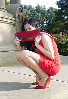 Sexy Tricia takes a stroll outdoors wearing a tight red dress with matching high heel shoes and handbag