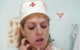 Skinny milf Nora opens pussy with speculum spreader