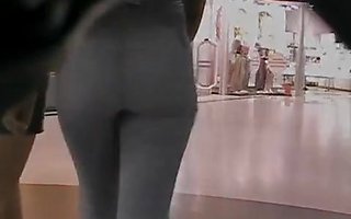 The sexy jeans girl is walking in front of me seductively teasing me with horny butts